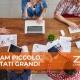 Team di lavoro impegnato a un tavolo con computer portatili e documenti